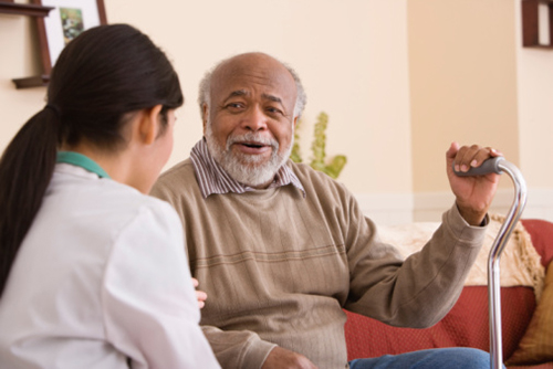 Nurse speaking with a patient while both are seated